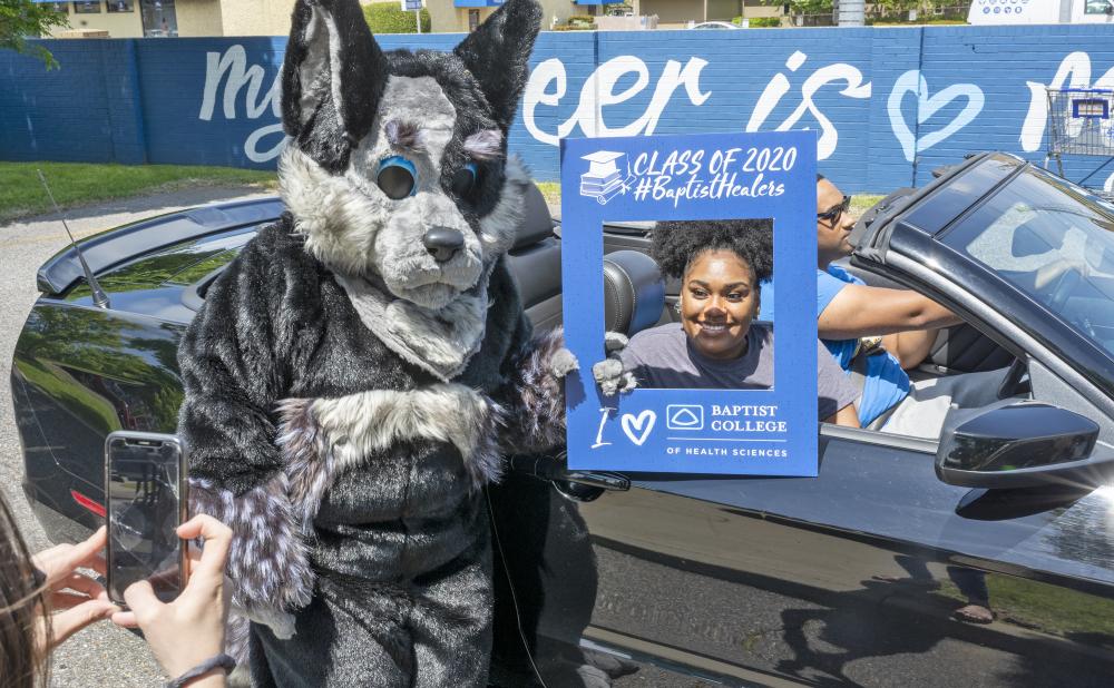 Blue Healer posing with April 2020 grad in drive-thru parade