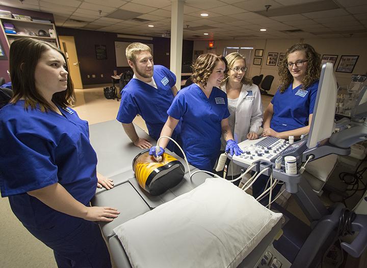 Students in diagnostic medical sonography scanning a model