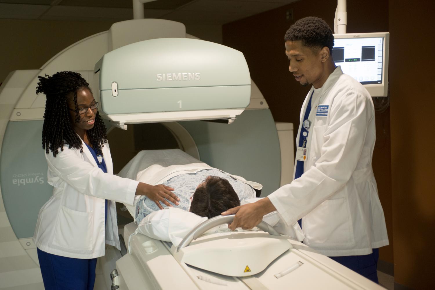 Students setting up patient for a scan