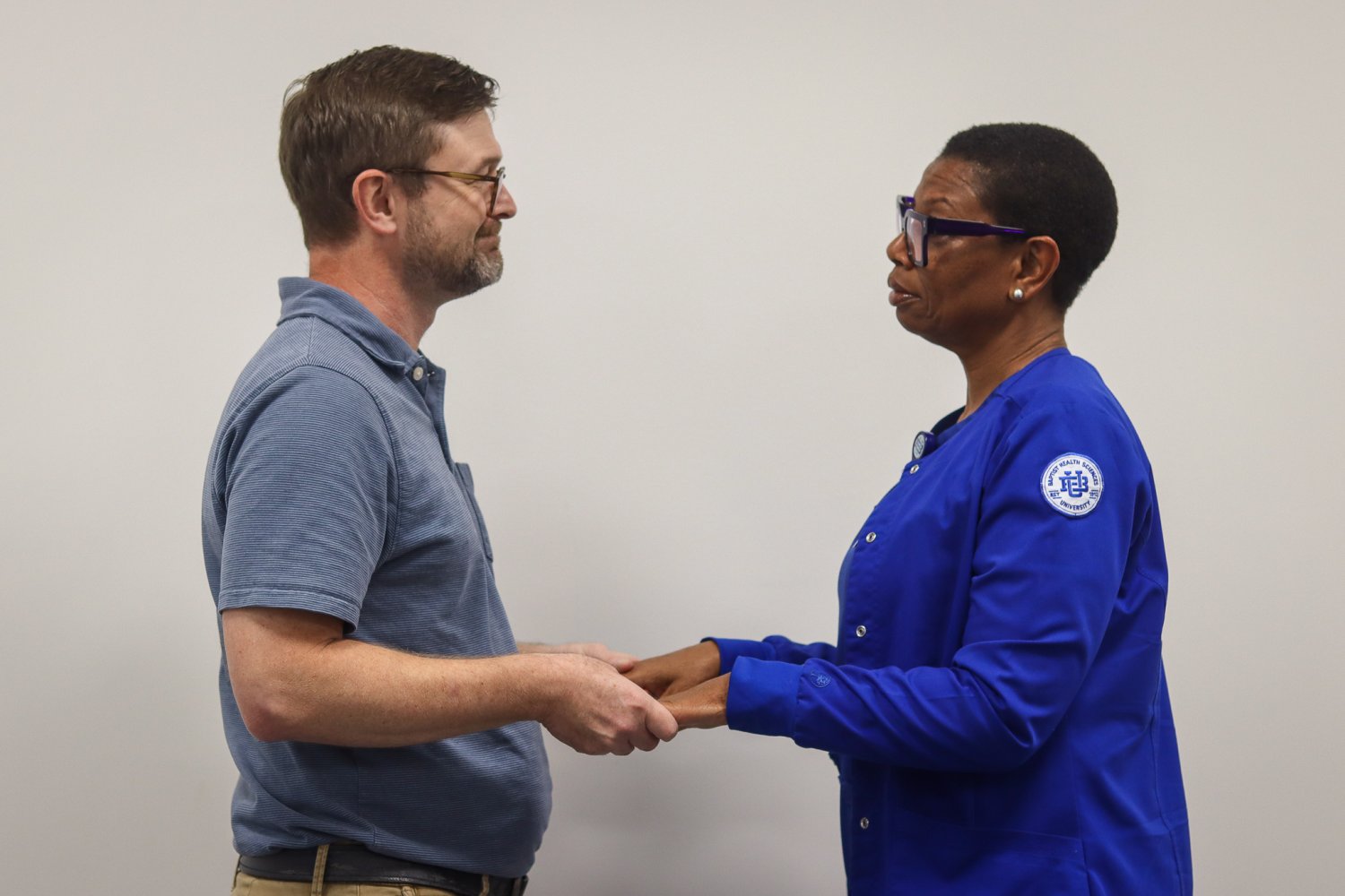 A BHSU faculty member holds a nursing student’s hands during the Blessing of the Hands ceremony.