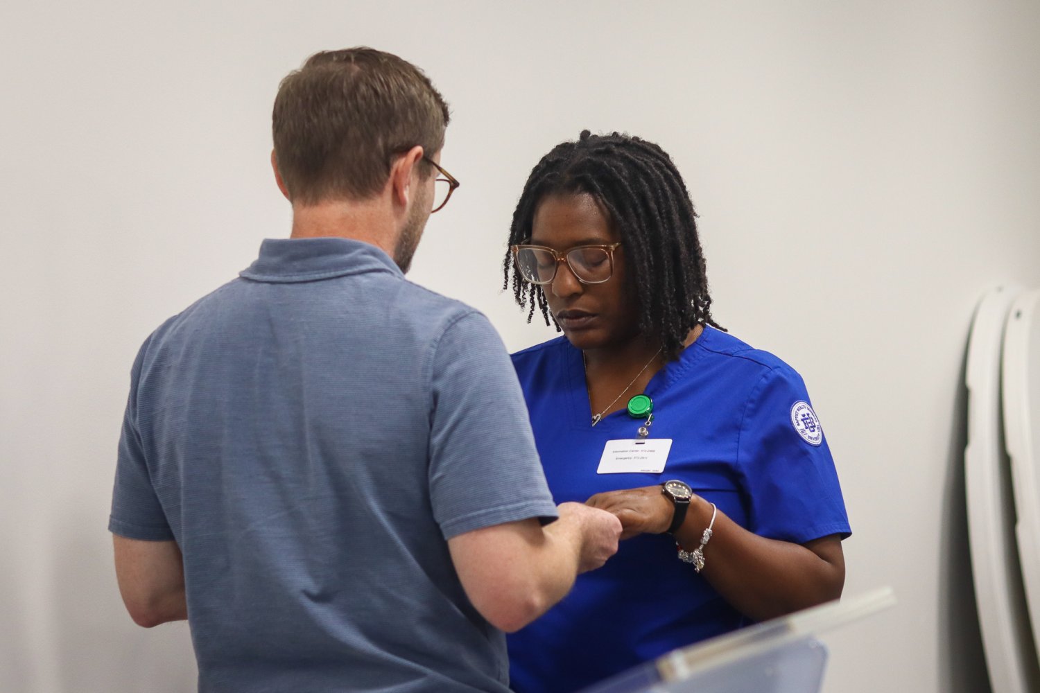 A nursing student closes her eyes in prayer as her hands are blessed during the ceremony.