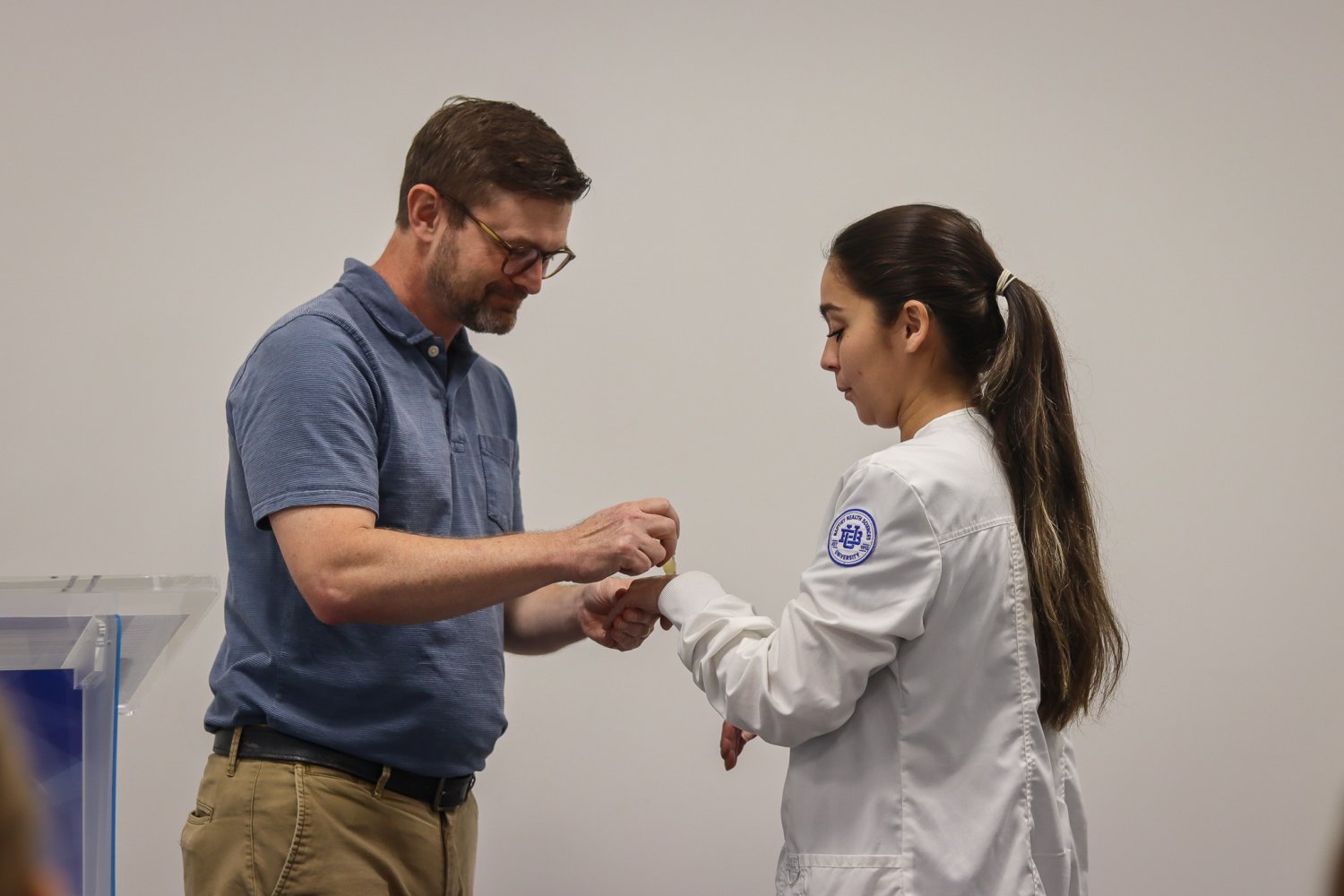 A BHSU nursing student bows her head as her hands are blessed during the Blessing of the Hands ceremony.