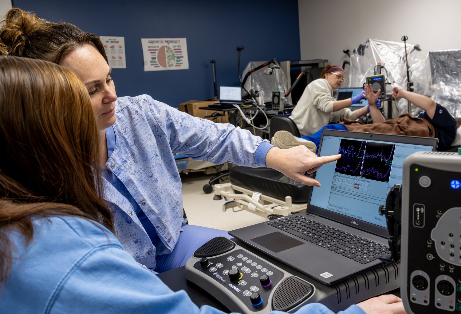 Students in an NDT lab use ultrasonic testing equipment to inspect materials during hands-on training.