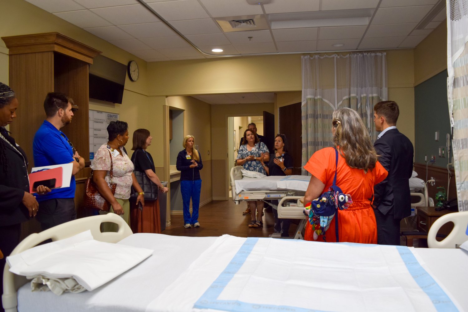 Brian Welton and BHSU staff tour a hospital room during a guided walkthrough of Baptist North Mississippi, engaging with clinical staff.