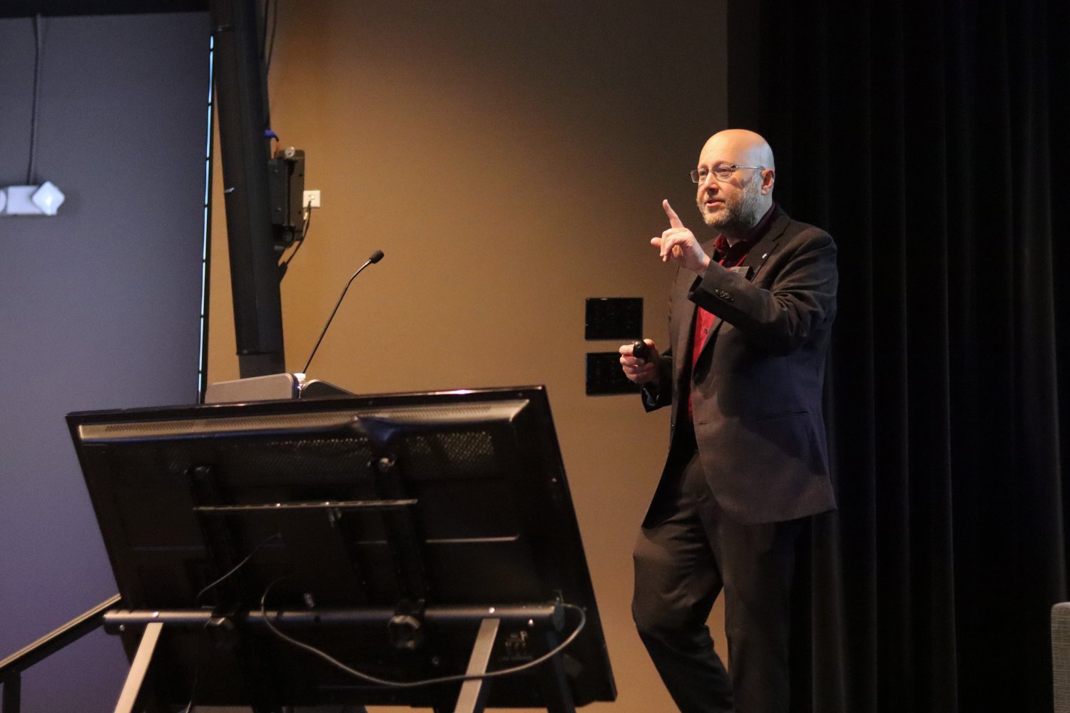 Dr. Arnold on the stage talking 