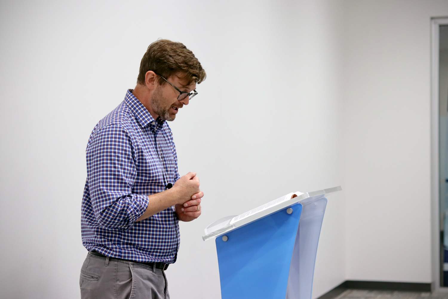 Rusty standing behind a podium 