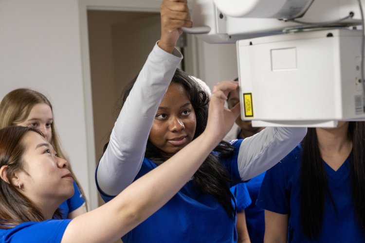 Smiling students learning in hands-on labs.