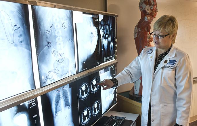 woman inspecting x-ray images