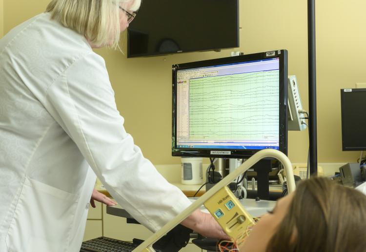 woman reading eeg on computer screen