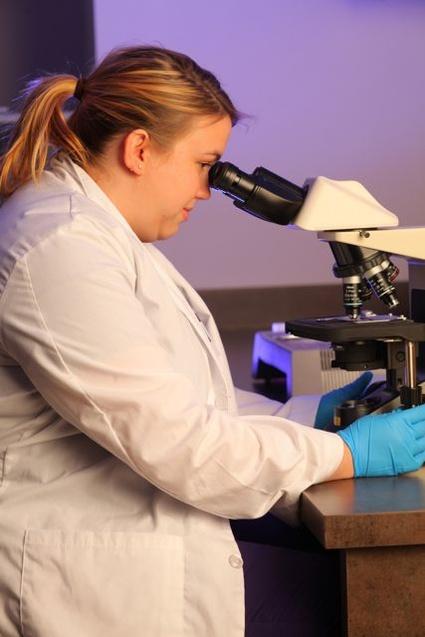 student at microscope