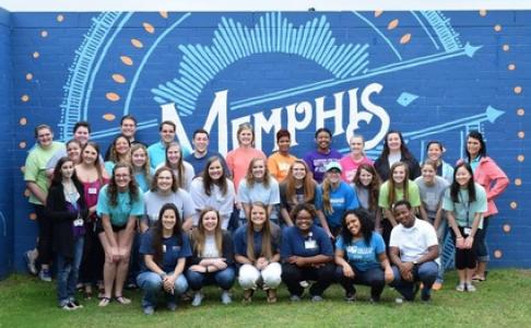 student leaders in front of a Memphis mural