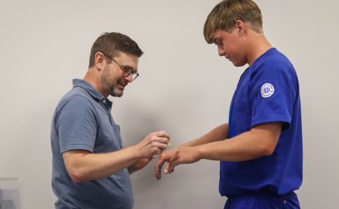 A BHSU faculty member anoints a nursing student’s hands during the Blessing of the Hands ceremony.