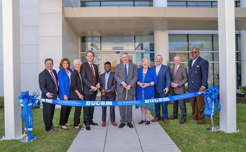 Leaders cutting the ribbon on the new BUCOM facility