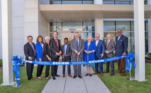 Leaders cutting the ribbon on the new BUCOM facility