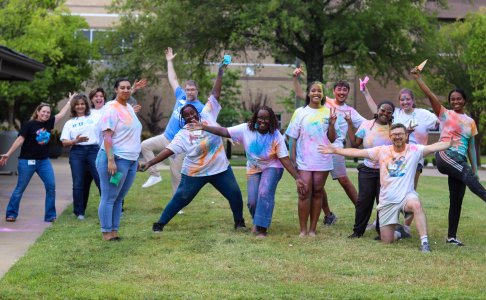 Students and faculty members wearing different colored shirts 