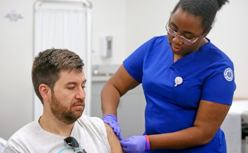 BHSU nursing student administers flu vaccine to faculty member during Employee Flu Clinic.