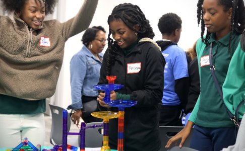 Three students at the event. One is celebrating 
